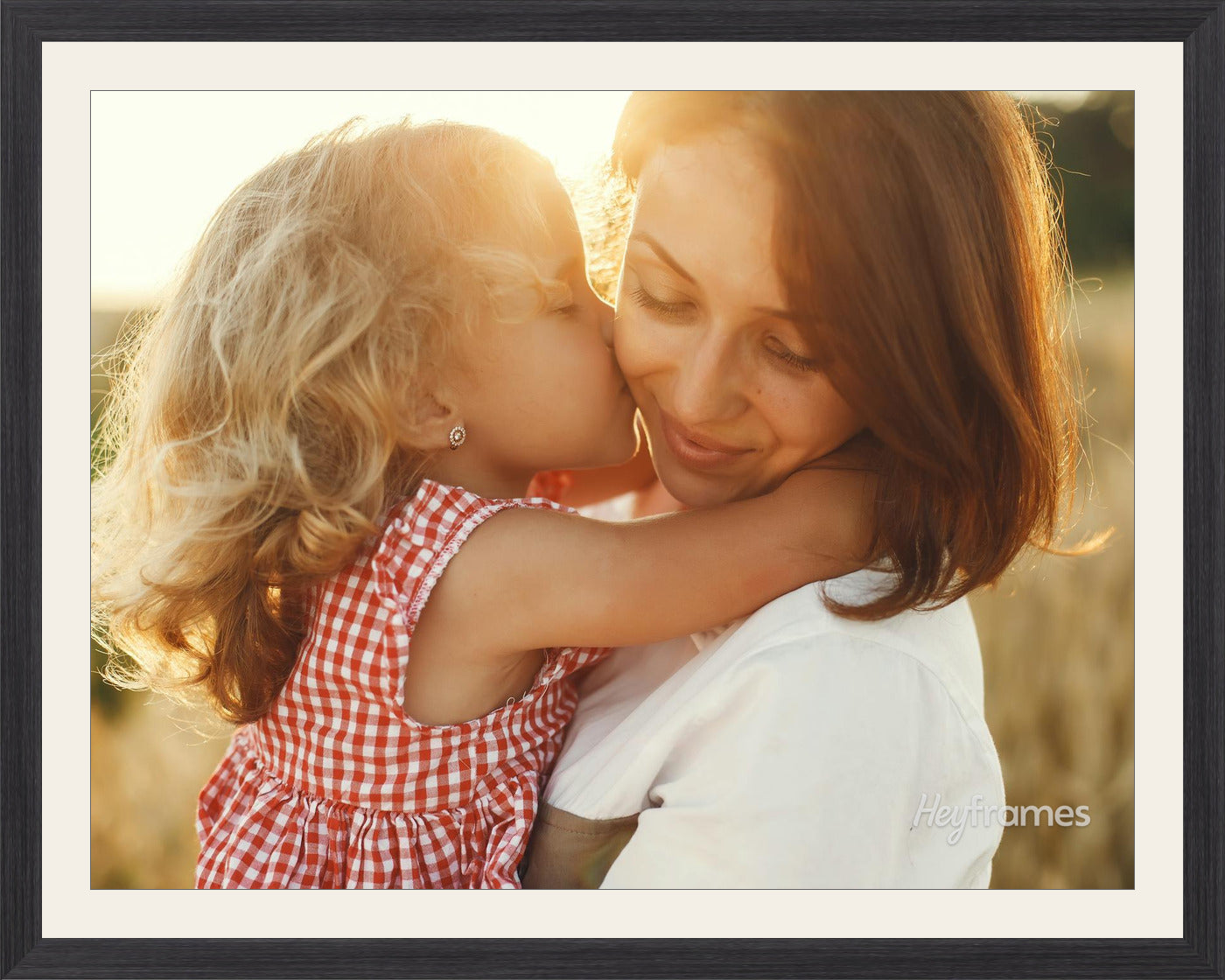 A baby photo in a soft white frame